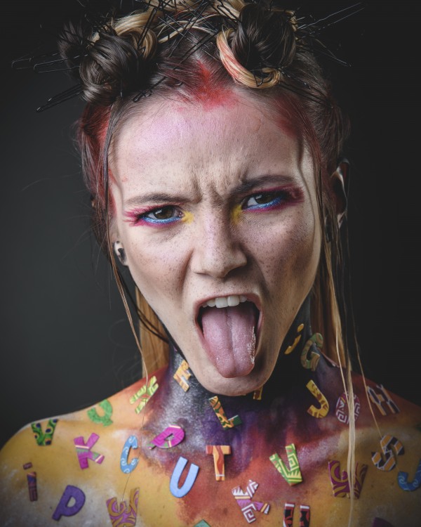 Young girl with creative alphabet makeup  by Faces Studio